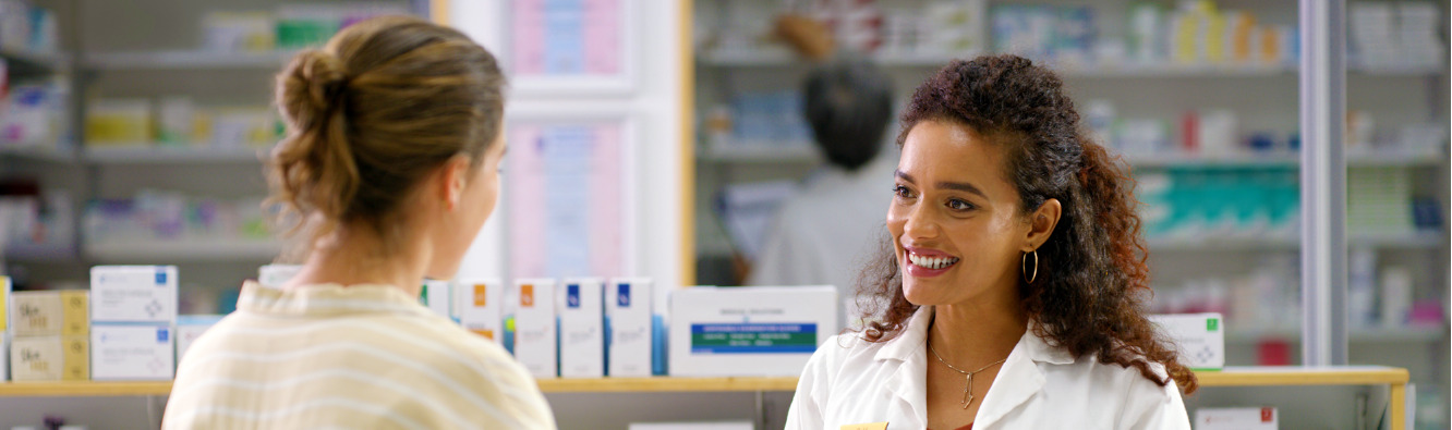 Woman speaking to pharmacist