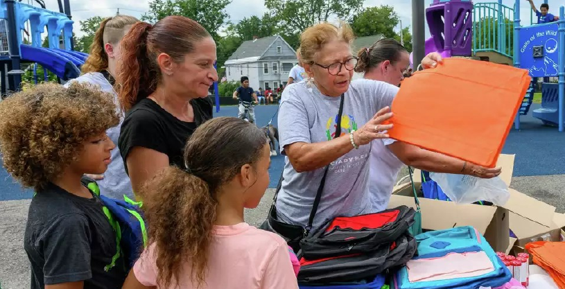 Families receiving backpacks for back to school